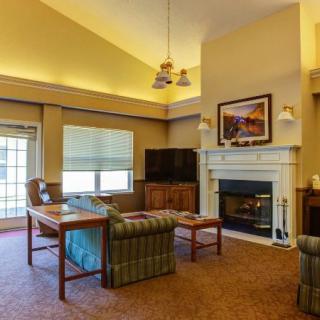 A cozy living room with a fireplace and comfortable seating.