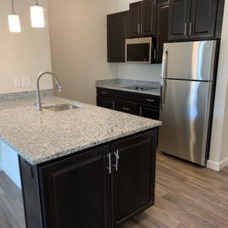 Modern kitchen with an island and stainless steel appliances.