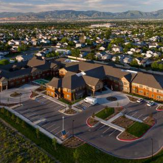 Aerial view of a large building surrounded by a suburban residential neighborhood.