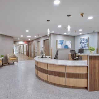 A contemporary medical office reception area featuring a spacious layout and inviting design.