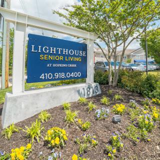 Welcome sign for Lighthouse Senior Living, surrounded by well-maintained landscaping.