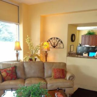 A cozy living room with a comfortable sofa, decorative pillows, and warm lighting.