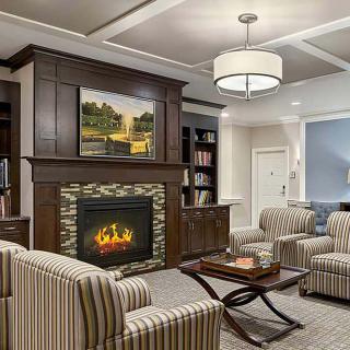 A cozy living room with a fireplace and elegant furnishings.