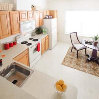 A bright kitchen and dining area in a modern apartment.