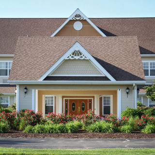 A beautiful residential house with a landscaped front yard and welcoming entrance.