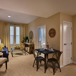 A cozy living and dining area with stylish furnishings and warm decor.