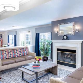 A modern living room with stylish furniture and a cozy fireplace.