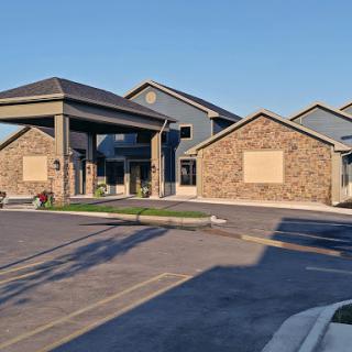 A modern commercial building featuring a stone exterior and clear blue skies.