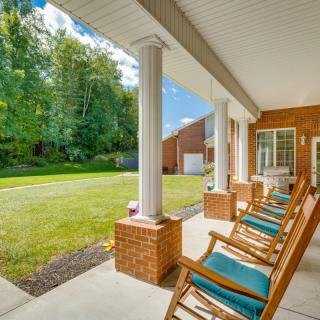 A cozy porch with rocking chairs overlooking a lush backyard.