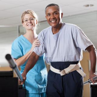 A therapist assists a patient during a rehabilitation session.