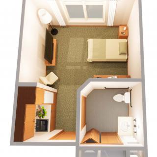 A compact studio apartment floor plan with a bedroom, bathroom, and kitchenette.