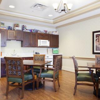 A cozy kitchen and dining area with wooden furniture and cabinets.
