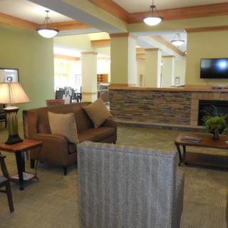 A cozy living room with comfortable seating and a fireplace.