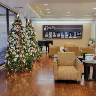 A beautifully decorated lobby featuring Christmas trees and comfortable seating.