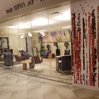 A serene view of the spa with a modern interior design, featuring a glass wall and stylish seating.