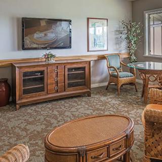 A cozy living room with wooden furniture and a mounted television.