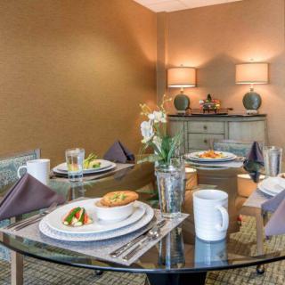 A beautifully set dining table with elegant decor and cozy lighting.