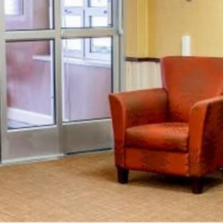 A cozy orange armchair in a well-lit waiting area.