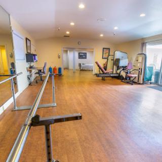 A well-equipped fitness and rehabilitation gym with a spacious layout.