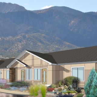 A modern house set against a backdrop of majestic mountains.