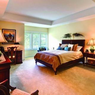 A cozy and well-decorated bedroom with soft lighting and elegant furnishings.