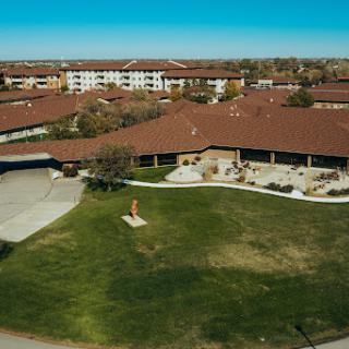 Aerial view of a residential complex featuring landscaped grounds and modern architecture.