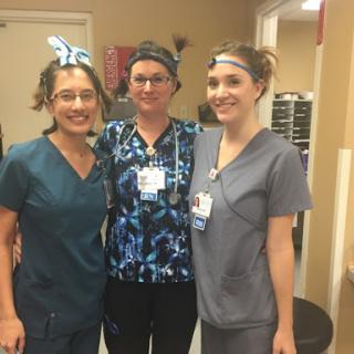 A group of dedicated healthcare professionals posing together in their scrubs.