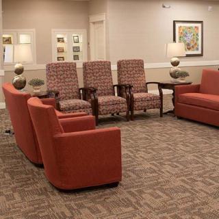 A cozy waiting room with comfortable seating and soft lighting.