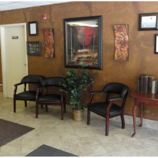 A welcoming waiting area featuring comfortable chairs and decorative artwork.