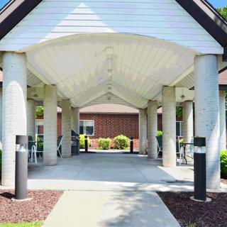 A covered entrance with columns leading to a building.