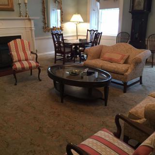 A cozy living room with elegant furniture, a fireplace, and warm lighting.