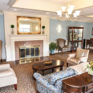 A cozy living room with elegant furniture and a fireplace.