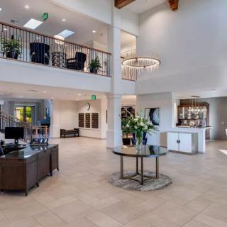 A spacious and modern lobby featuring elegant furniture and stylish lighting.