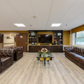 A cozy and modern lounge area designed for relaxation and comfort, featuring stylish furniture and a television.