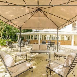 Outdoor patio area with comfortable seating under a canopy.
