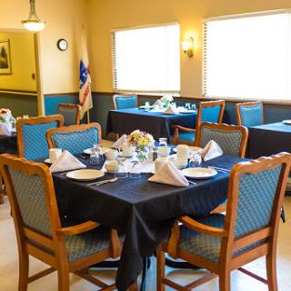 A beautifully arranged dining area with tables set for a special occasion.