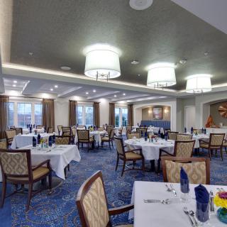 An elegant dining room with neatly set tables and stylish lighting.