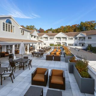 Elegant outdoor patio area at a resort with comfortable seating and scenic surroundings.