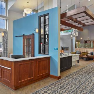 A modern restaurant interior with stylish wooden accents and contemporary lighting.