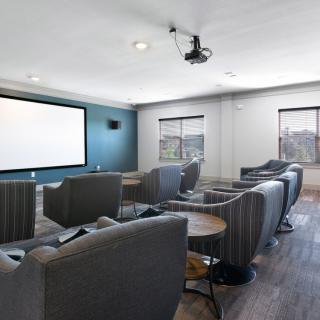 Modern home theater with comfortable seating and a large screen.