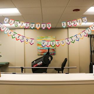 A vibrant office space decorated with a colorful banner and exercise equipment in the background.