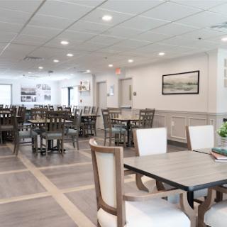 A well-lit and spacious dining area featuring modern furniture.