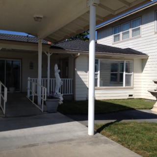 A residential house with a driveway and front yard.