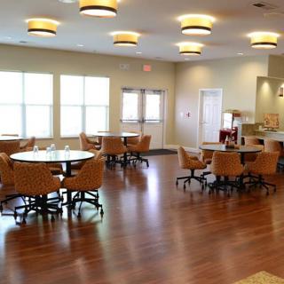 Spacious dining area with wooden floors and ample lighting.
