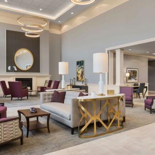 A luxurious and modern hotel lobby with elegant seating arrangements and sophisticated decor.