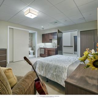 A modern and cozy bedroom featuring a guitar and floral decor.