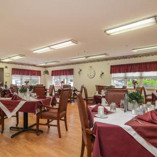 A well-decorated dining area with tables and chairs neatly arranged.