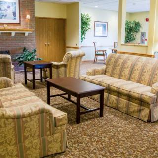 A cozy living room with patterned sofas and a central coffee table.