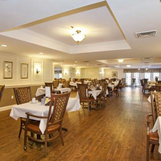 Elegant dining room with neatly arranged tables and chairs.