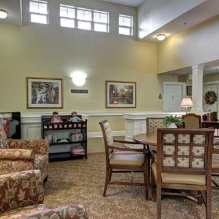 A cozy living room interior with comfortable seating and wall art.